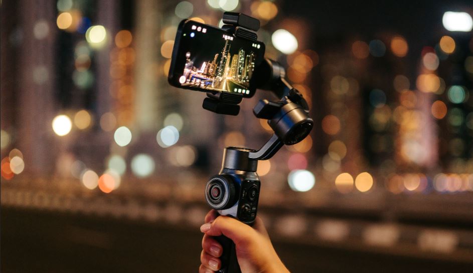 Person shooting pictures for tiktok at night in the street